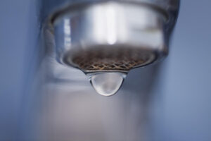 %Title% | 3 Mountains Home Services A close up picture of a faucet with one drop almost ready to fall.