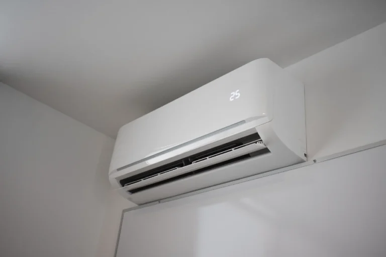A 3 Mountains Home Services technician has set a wall-mounted air conditioner to 25°C in a freshly serviced, bright white room.