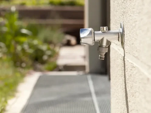 a frost free spigot extends from the outside wall of a home.