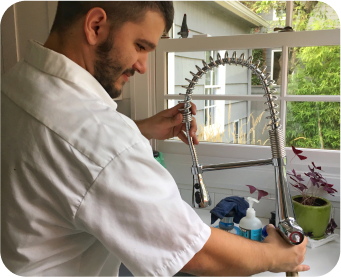 Plumbing Tech working on sink